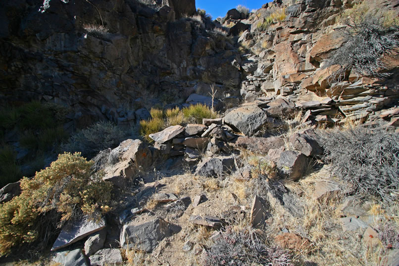 However, nothing turns up except an enigmatic low stacked rock wall.  Again, we wonder if it might have been used as a hunting blind to ambush animals as they traveled up and down the canyon.