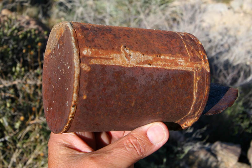 A very old side soldered hole and cap can is also found below the cabin site.