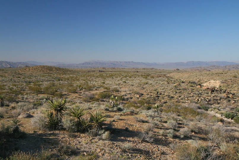 Colin Fletcher relates that, "Down toward the mouth of the canyon stand blocked outcrops of warm brown granite...Beyond stretches wide plain, then distant hills.  Above hangs wide sky and silence."  This is where we'll spend the night.