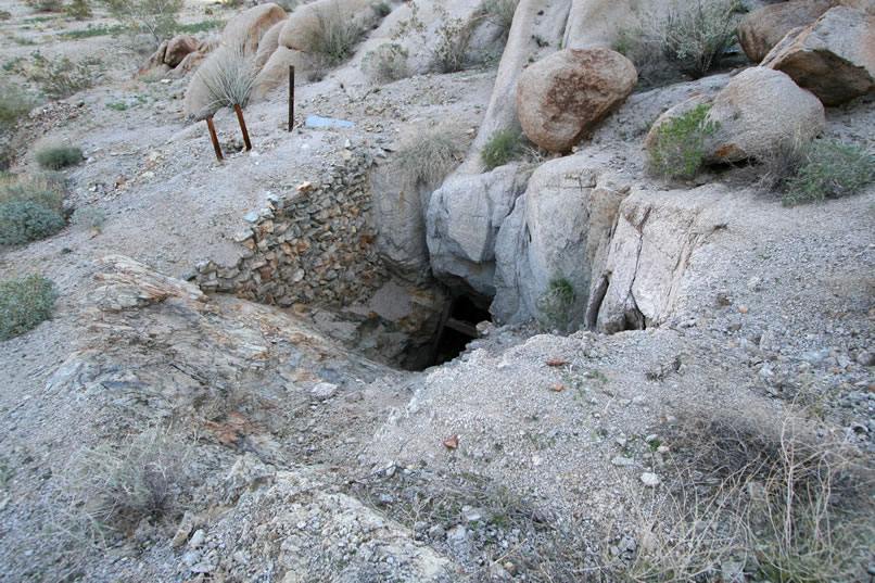 To the right of the stacked stone wall is the inclined shaft.  It's badly caved in.