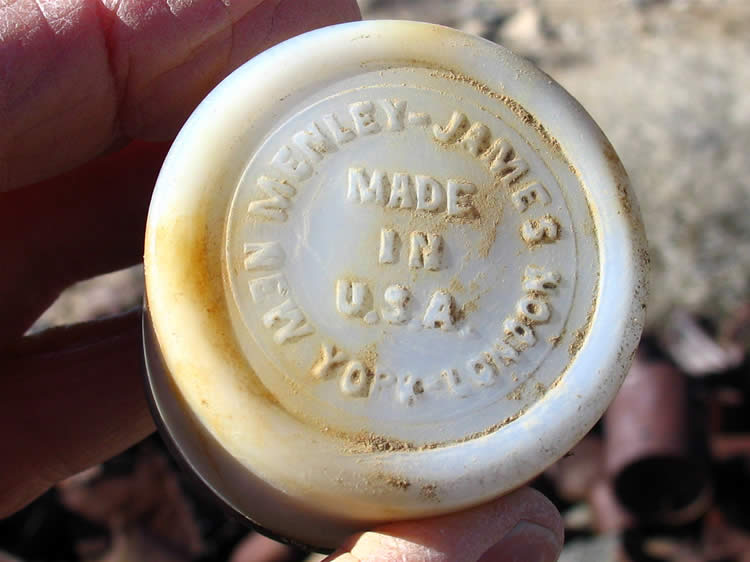 A heavy white glass tub with the lid still intact from the same maker as the Iodex product.