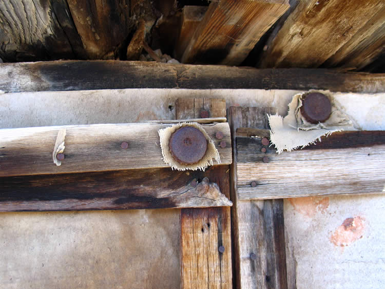 Here's a closer view showing a few of the remaining bottle caps with the canvas still held tightly in place behind them.