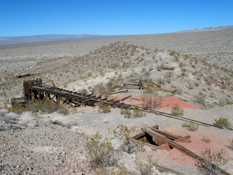 Niki scrambles up the hillside to get a better view of the area.  Notice the shaft to the right.  The main shaft and its headframe is out of the photo further to the right.