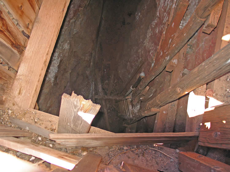 The shaft itself looks in bad shape with an apparent cave-in and lots of debris choking its lower level. 