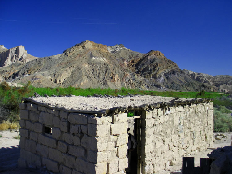 A good look at the locally quarried blocks of tuff that form the walls of the structure and also the colorful Sperry Hills in the distance.