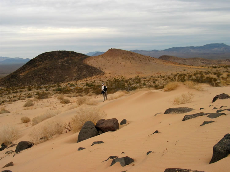 Jamie stops in our sandy uphill slog to photograph what we've named "Yin Yang Hill."