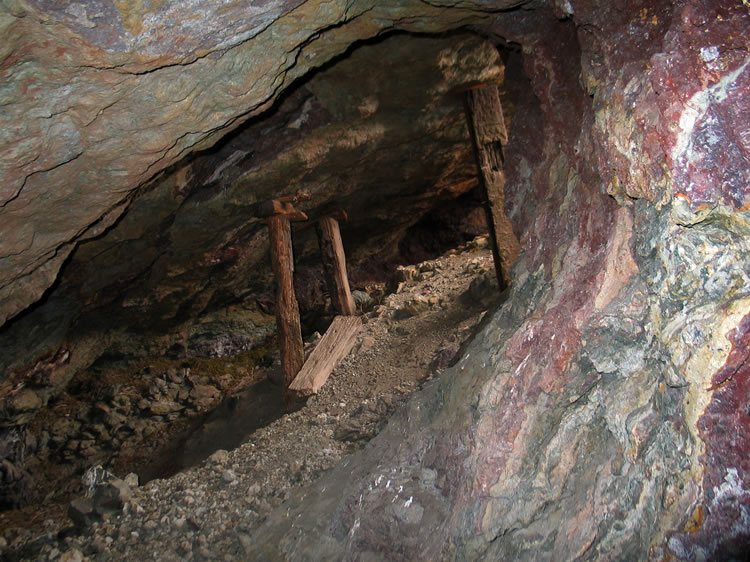 The tunnel gives access to the bottom of an open stope that Niki is exploring from above.