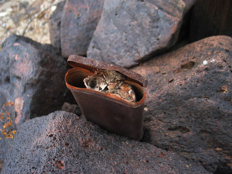 Following an old footpath down to a nearby wash results in finding a cairn with some claim papers still intact.