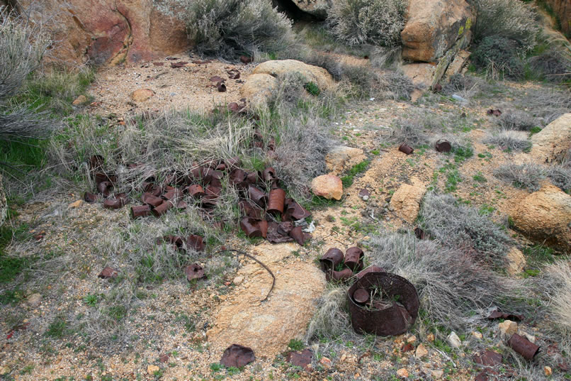 As we start to pick our way uphill through the boulders in the direction of the tailings, we begin to see lots of can scatters.