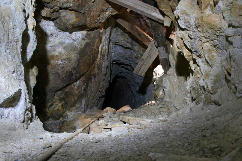 On the way out, after safely crossing the pit again, Niki tries a timed exposure by setting her camera on the tunnel floor and using the available light that filters down the shaft from above.