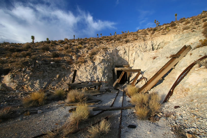The tracks that we've been following lead to the main adit.  There's a work bench to the left and the possible remains of a small shed.