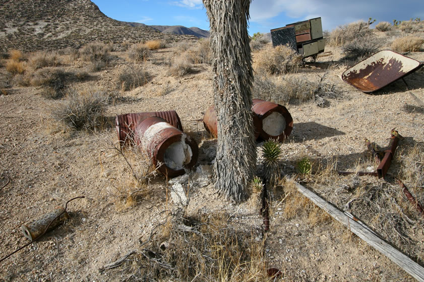 The large drums in the center of the photo are carbide containers.  Also notice the large cookstove and wheelbarrow body off to the right.