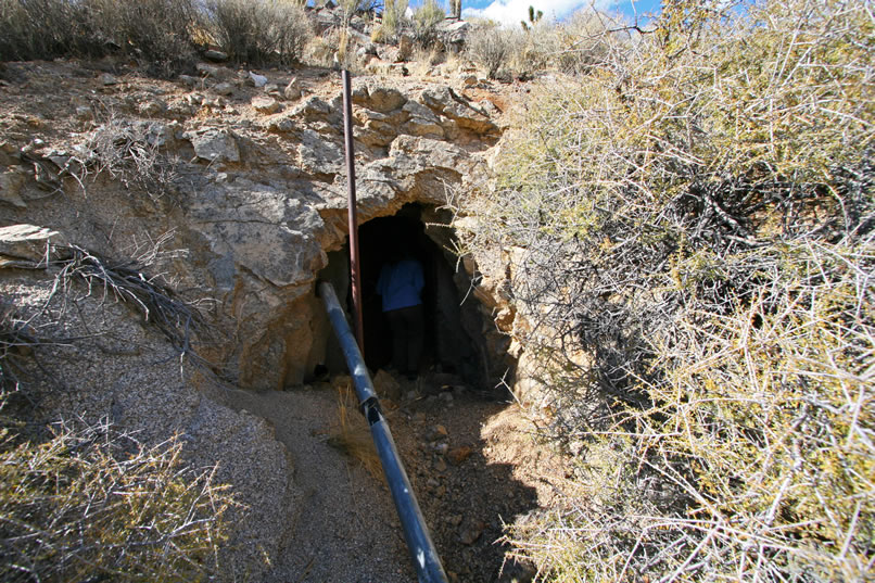 Nearby, burrowed into the side of the hill, is a well-built little explosives magazine.