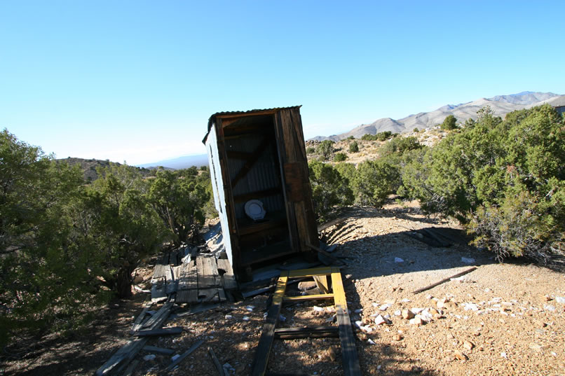 Across the way is a rock lined path that leads to an outhouse.