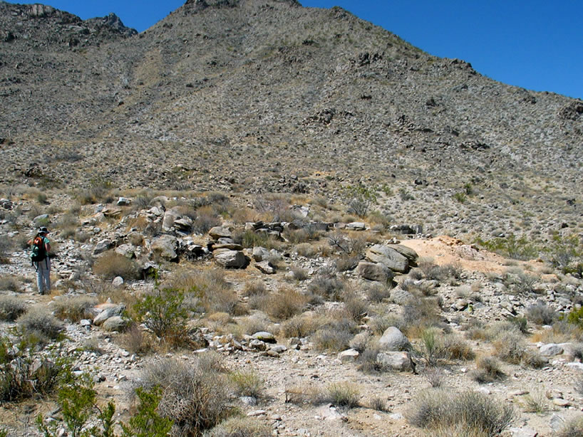 The light colored tailings that Niki is heading for are quite distinctive and indicate that a mill once operated here.
