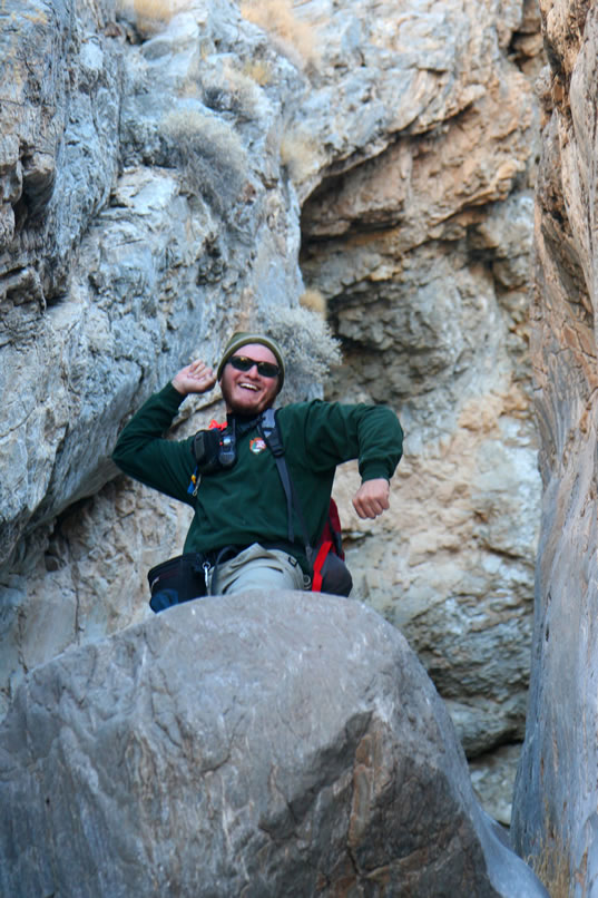 After his celebration at making it up the rockfall, Dan gets busy and drops down some webbing so that we can scramble up also.