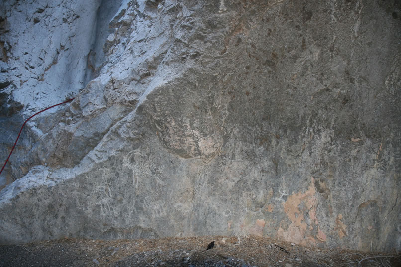 While Micah gingerly picks his way upward, we check out the petros on the rock to the right of the chute with Micah's rope trailing from it.